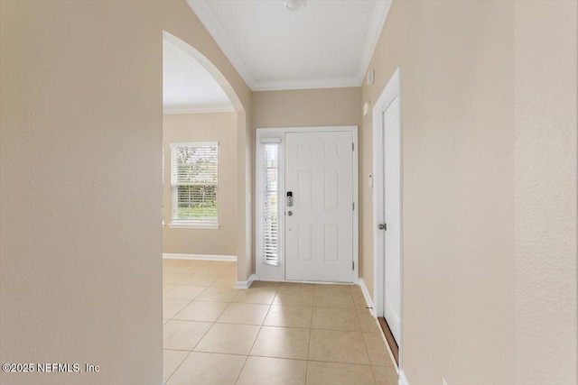 165 Crown Colony Rd, Saint Augustine, FL 32092 - entrance foyer featuring arched walkways, crown molding, light tile patterned flooring, and baseboards