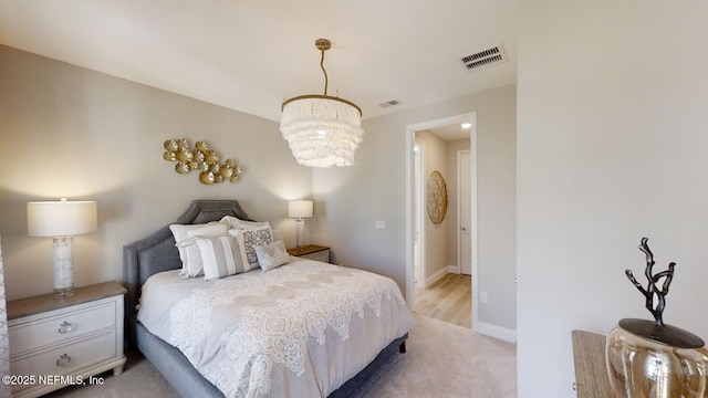 527 Superior Blvd, Saint Johns, FL 32092 - bedroom with a chandelier, light colored carpet, and baseboards