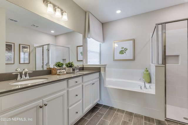 527 Superior Blvd, Saint Johns, FL 32092 - full bath with a stall shower, double vanity, a garden tub, and wood finished floors