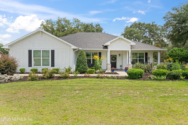 6228 Blue Marlin Dr, Keystone Heights, FL 32656 - view of front facade with board and batten siding, a front yard, and a shingled roof