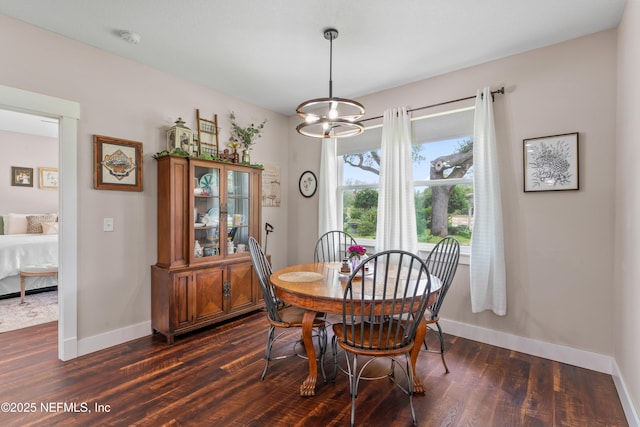 6228 Blue Marlin Dr, Keystone Heights, FL 32656 - dining area featuring dark wood finished floors, a chandelier, and baseboards
