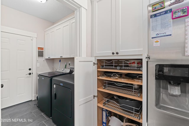 6228 Blue Marlin Dr, Keystone Heights, FL 32656 - laundry area featuring cabinet space, independent washer and dryer, and dark tile patterned flooring