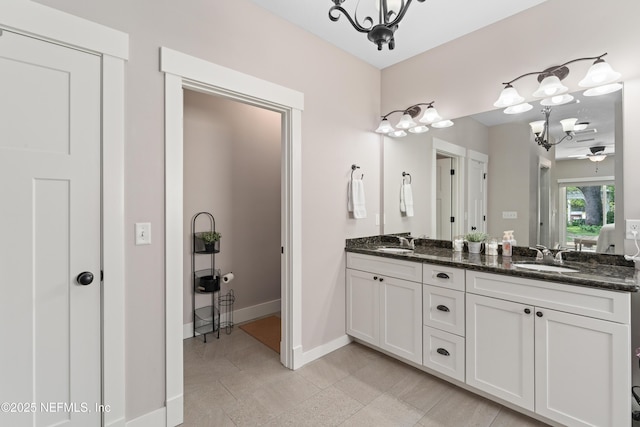 6228 Blue Marlin Dr, Keystone Heights, FL 32656 - full bath with a chandelier, double vanity, and baseboards