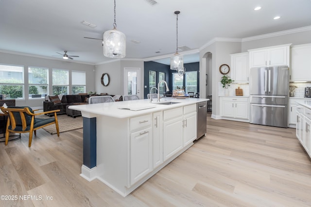 18 Myrtle Brook Bnd, Ponte Vedra, FL 32081 - kitchen with appliances with stainless steel finishes, a sink, a ceiling fan, light wood-style floors, and ornamental molding