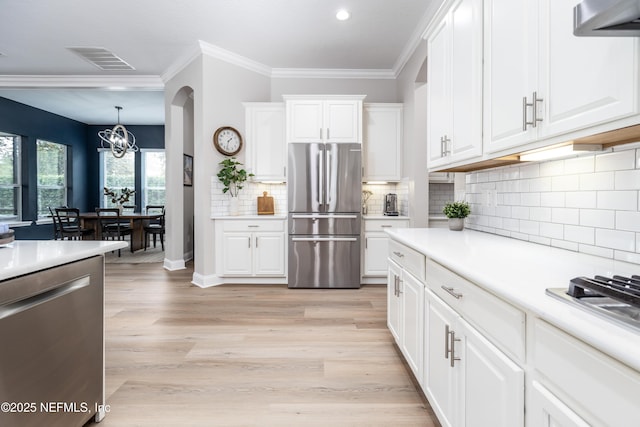 18 Myrtle Brook Bnd, Ponte Vedra, FL 32081 - kitchen featuring appliances with stainless steel finishes, a chandelier, light countertops, white cabinetry, and light wood-style flooring