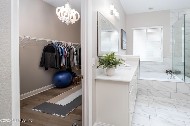 18 Myrtle Brook Bnd, Ponte Vedra, FL 32081 - full bath with vanity, a bath, a chandelier, a walk in closet, and a tile shower