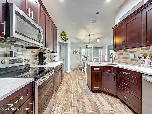 3923 Eden Estate Trl, Middleburg, FL 32068 - kitchen with stainless steel appliances, a sink, and light countertops