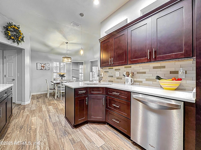 3923 Eden Estate Trl, Middleburg, FL 32068 - kitchen featuring dishwasher, a sink, light countertops, backsplash, and a peninsula