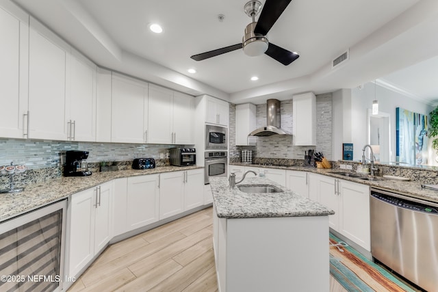 1925 S Atlantic Ave Unit 810, Daytona Beach Shores, FL 32118 - kitchen with wine cooler, appliances with stainless steel finishes, wall chimney exhaust hood, a sink, and recessed lighting