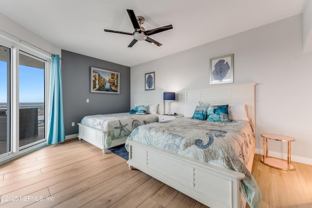 1925 S Atlantic Ave Unit 810, Daytona Beach Shores, FL 32118 - bedroom featuring access to outside, wood finished floors, baseboards, and ceiling fan