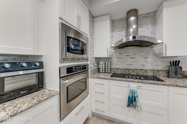 1925 S Atlantic Ave Unit 810, Daytona Beach Shores, FL 32118 - kitchen with wall chimney exhaust hood, stainless steel appliances, and decorative backsplash