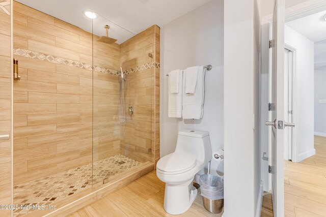 1925 S Atlantic Ave Unit 810, Daytona Beach Shores, FL 32118 - bathroom with wood finished floors, tiled shower, toilet, and recessed lighting