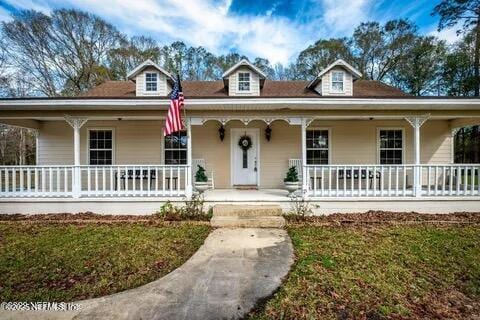 2443 SE 150th St, Starke, FL 32091 - farmhouse-style home with a porch