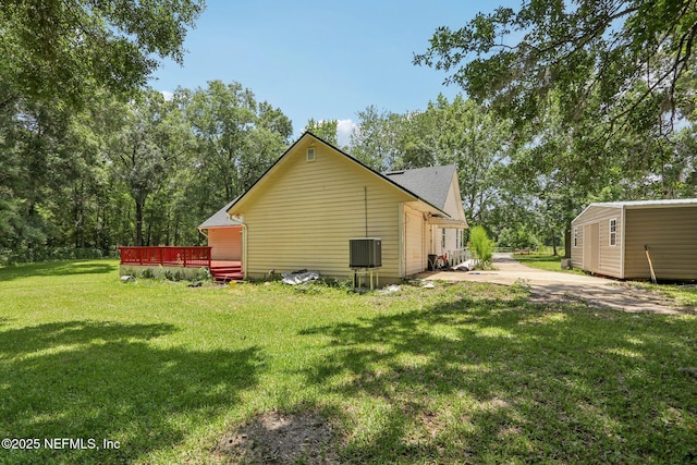 2443 SE 150th St, Starke, FL 32091 - view of side of property with an outbuilding, a yard, a wooden deck, and a patio