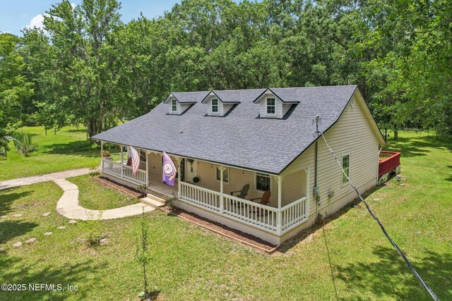 2443 SE 150th St, Starke, FL 32091 - farmhouse with a shingled roof, a porch, and a front yard