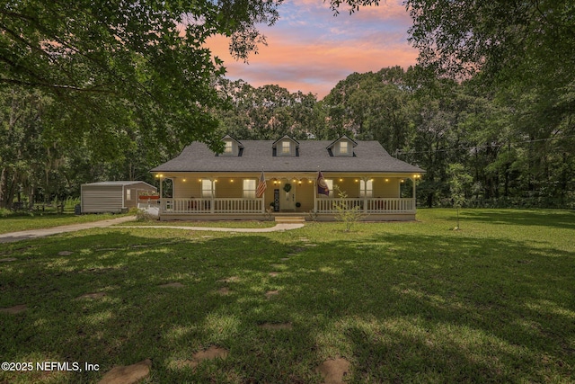 2443 SE 150th St, Starke, FL 32091 - rear view of property featuring a porch, a shed, and a lawn