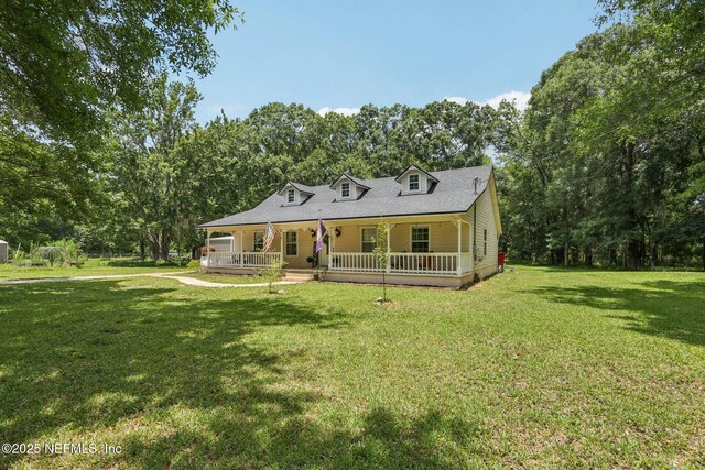 2443 SE 150th St, Starke, FL 32091 - view of front of home with a porch, a front yard, and view of scattered trees