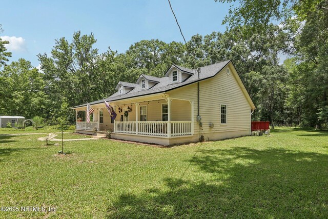 2443 SE 150th St, Starke, FL 32091 - view of front of property with a porch, a front lawn, and view of wooded area