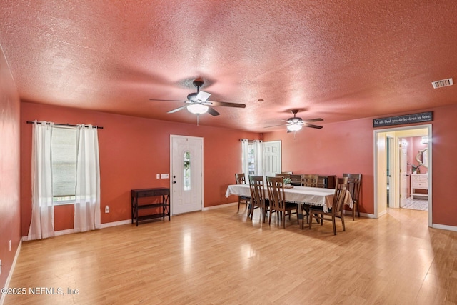 2443 SE 150th St, Starke, FL 32091 - dining room with a textured ceiling, wood finished floors, and ceiling fan