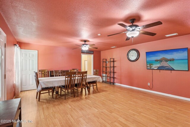 2443 SE 150th St, Starke, FL 32091 - dining room with a textured ceiling, ceiling fan, and light wood-style flooring