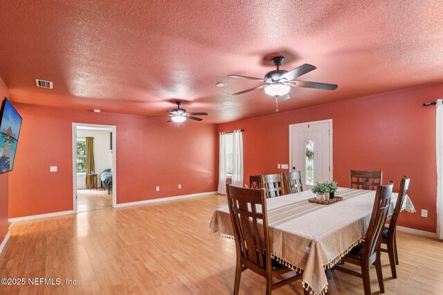 2443 SE 150th St, Starke, FL 32091 - dining area with a textured ceiling, light wood-type flooring, and a ceiling fan