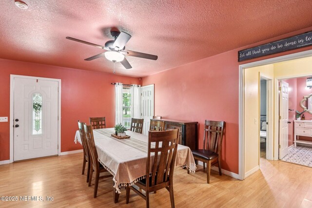 2443 SE 150th St, Starke, FL 32091 - dining room with wood finished floors, a textured ceiling, and ceiling fan