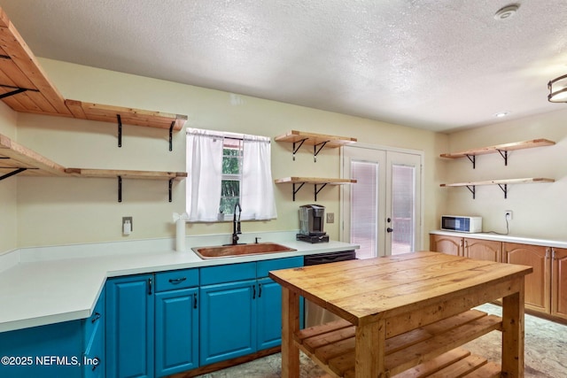 2443 SE 150th St, Starke, FL 32091 - kitchen featuring open shelves, blue cabinetry, french doors, white microwave, and light countertops
