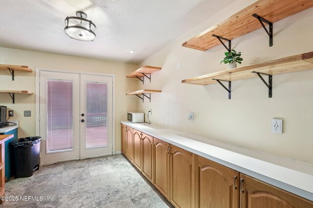 2443 SE 150th St, Starke, FL 32091 - kitchen featuring open shelves, french doors, and white microwave