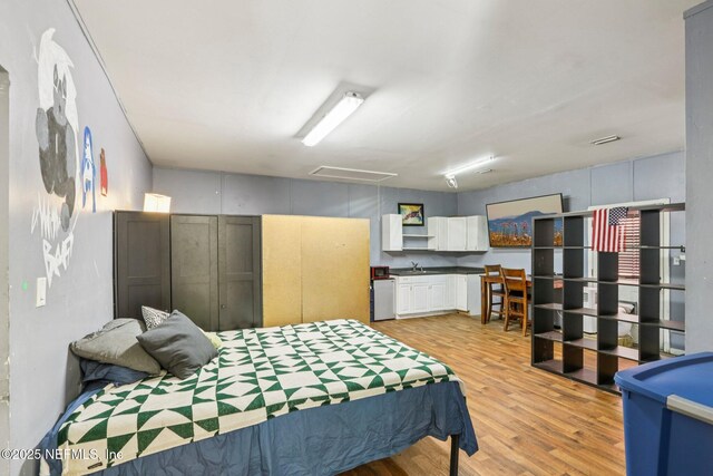 2443 SE 150th St, Starke, FL 32091 - bedroom with attic access and light wood-style flooring