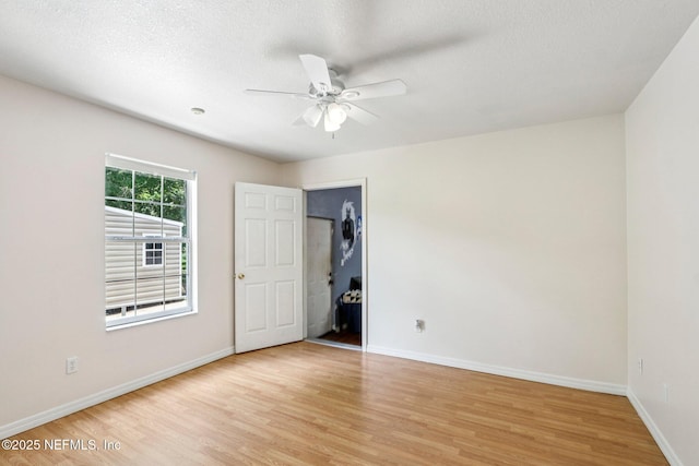 2443 SE 150th St, Starke, FL 32091 - unfurnished bedroom with light wood-style floors, a textured ceiling, and ceiling fan