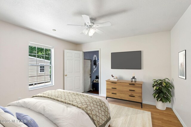 2443 SE 150th St, Starke, FL 32091 - bedroom featuring wood finished floors, ceiling fan, and a textured ceiling