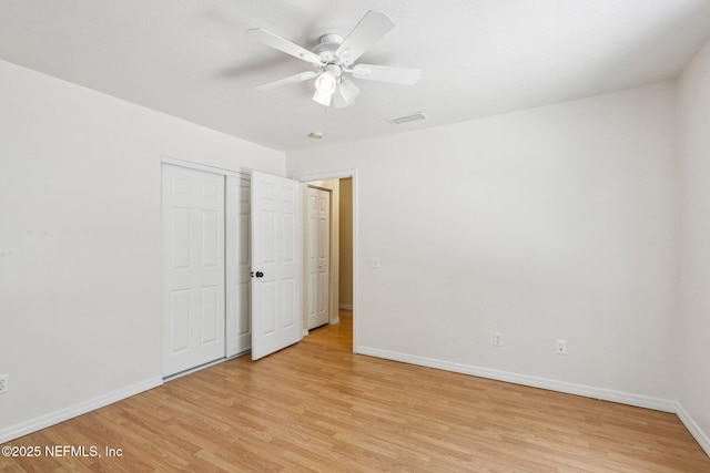 2443 SE 150th St, Starke, FL 32091 - unfurnished bedroom featuring light wood-style floors, a ceiling fan, and a closet