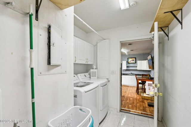 2443 SE 150th St, Starke, FL 32091 - laundry area featuring separate washer and dryer, electric panel, and cabinet space