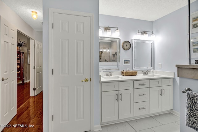 5365 Navigators Way, Jacksonville, FL 32277 - bathroom featuring a textured ceiling and double vanity