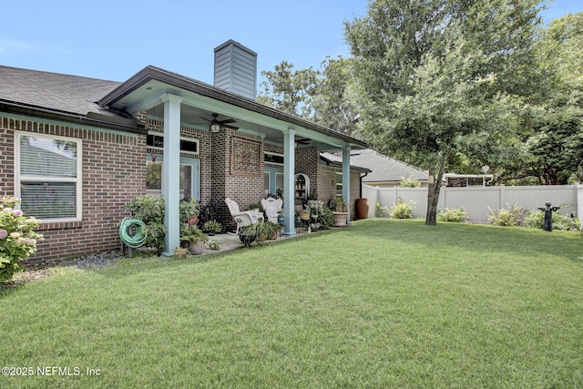5365 Navigators Way, Jacksonville, FL 32277 - rear view of property featuring a ceiling fan, brick siding, a chimney, and a patio area