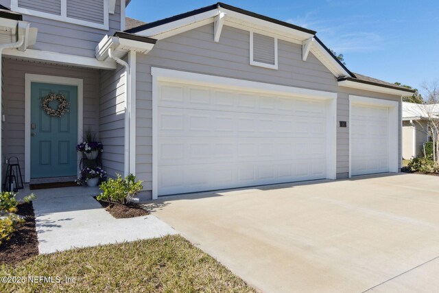 14 Rambling Ln, Palm Coast, FL 32164 - garage with concrete driveway