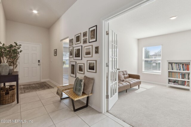 14 Rambling Ln, Palm Coast, FL 32164 - foyer entrance featuring light tile patterned floors, baseboards, and light carpet