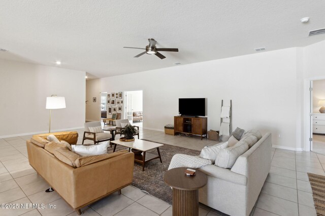14 Rambling Ln, Palm Coast, FL 32164 - living area featuring light tile patterned floors, a ceiling fan, baseboards, and a textured ceiling