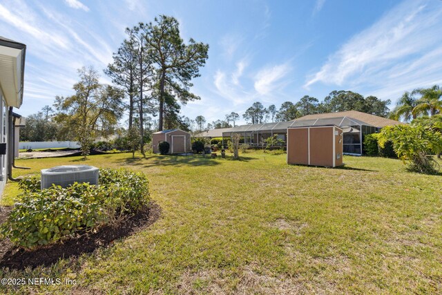 14 Rambling Ln, Palm Coast, FL 32164 - view of grassy yard with central air condition unit and glass enclosure