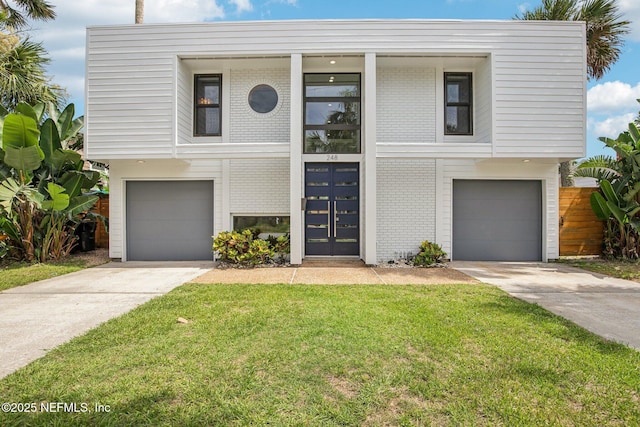248 11th St, Atlantic Beach, FL 32233 - view of front of house with brick siding, a garage, a front lawn, and driveway