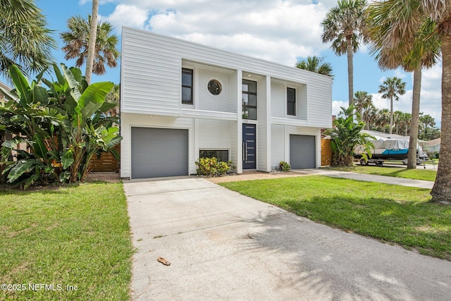 248 11th St, Atlantic Beach, FL 32233 - view of front facade featuring an attached garage, driveway, and a front yard