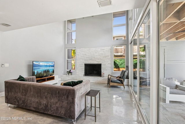 248 11th St, Atlantic Beach, FL 32233 - living area featuring a stone fireplace and a towering ceiling