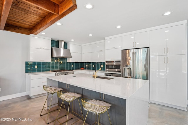 248 11th St, Atlantic Beach, FL 32233 - kitchen featuring modern cabinets, appliances with stainless steel finishes, wall chimney range hood, concrete flooring, and tasteful backsplash