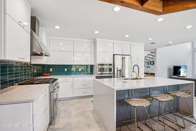 248 11th St, Atlantic Beach, FL 32233 - kitchen with stainless steel appliances, modern cabinets, white cabinets, a kitchen bar, and recessed lighting