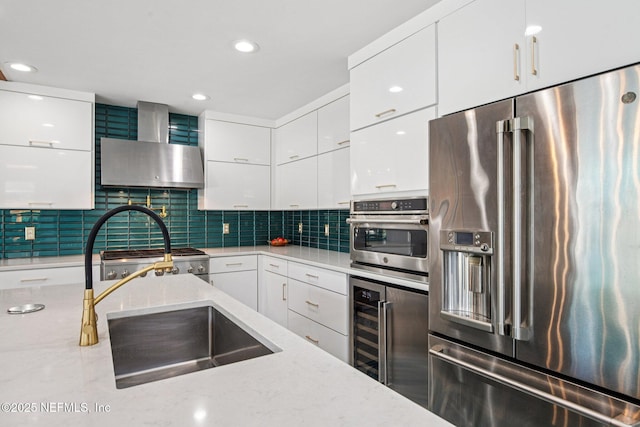 248 11th St, Atlantic Beach, FL 32233 - kitchen featuring appliances with stainless steel finishes, wall chimney exhaust hood, wine cooler, modern cabinets, and white cabinets