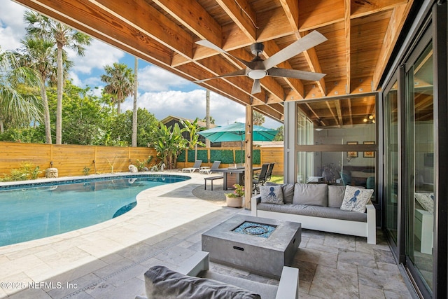 248 11th St, Atlantic Beach, FL 32233 - fenced backyard featuring a patio, an outdoor living space with a fire pit, and ceiling fan