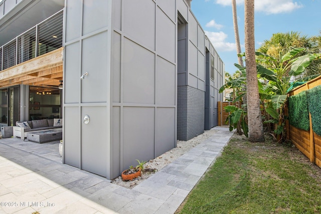 248 11th St, Atlantic Beach, FL 32233 - view of property exterior featuring an outdoor fire pit and brick siding