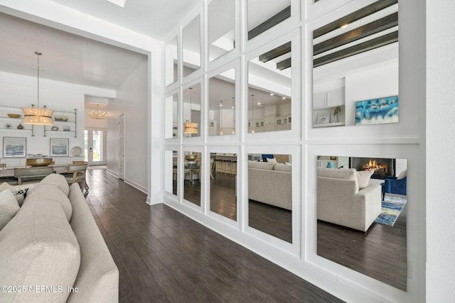 97 Marquesa Cir, Saint Johns, FL 32259 - living area featuring dark wood finished floors, a chandelier, and a lit fireplace