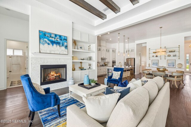 97 Marquesa Cir, Saint Johns, FL 32259 - living area featuring dark wood-style flooring, a warm lit fireplace, beam ceiling, and a chandelier
