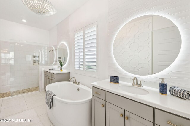 97 Marquesa Cir, Saint Johns, FL 32259 - full bath with two vanities, a freestanding tub, walk in shower, and tile patterned flooring